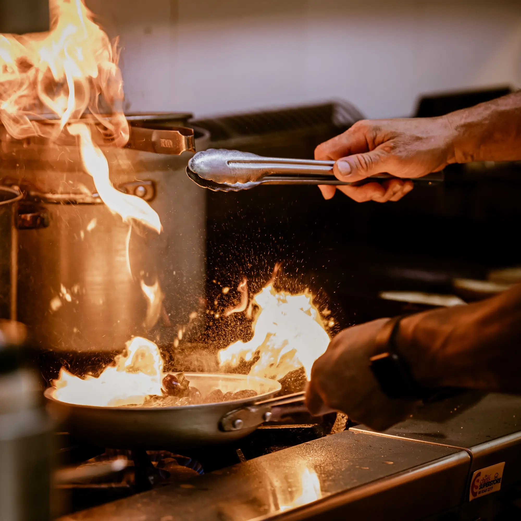 Joe Paladino flipping food in a fry pan.