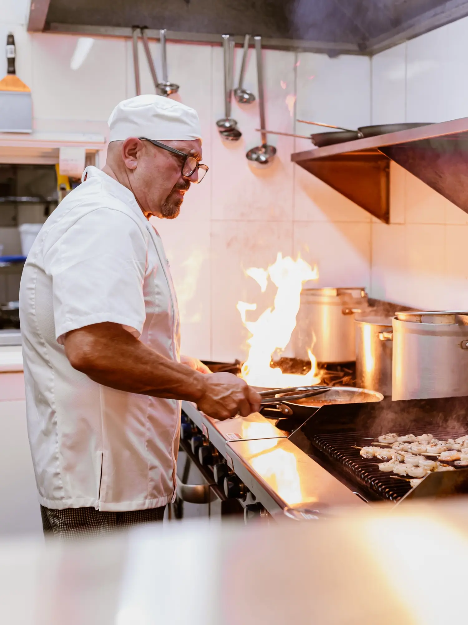 Joe Paladino cooking in food in the restaurant.