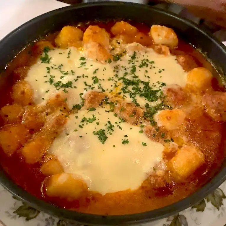 Gnocchi cooked in a red sauce.